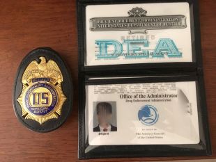 Retired DEA agent credentials with identifying information redacted.